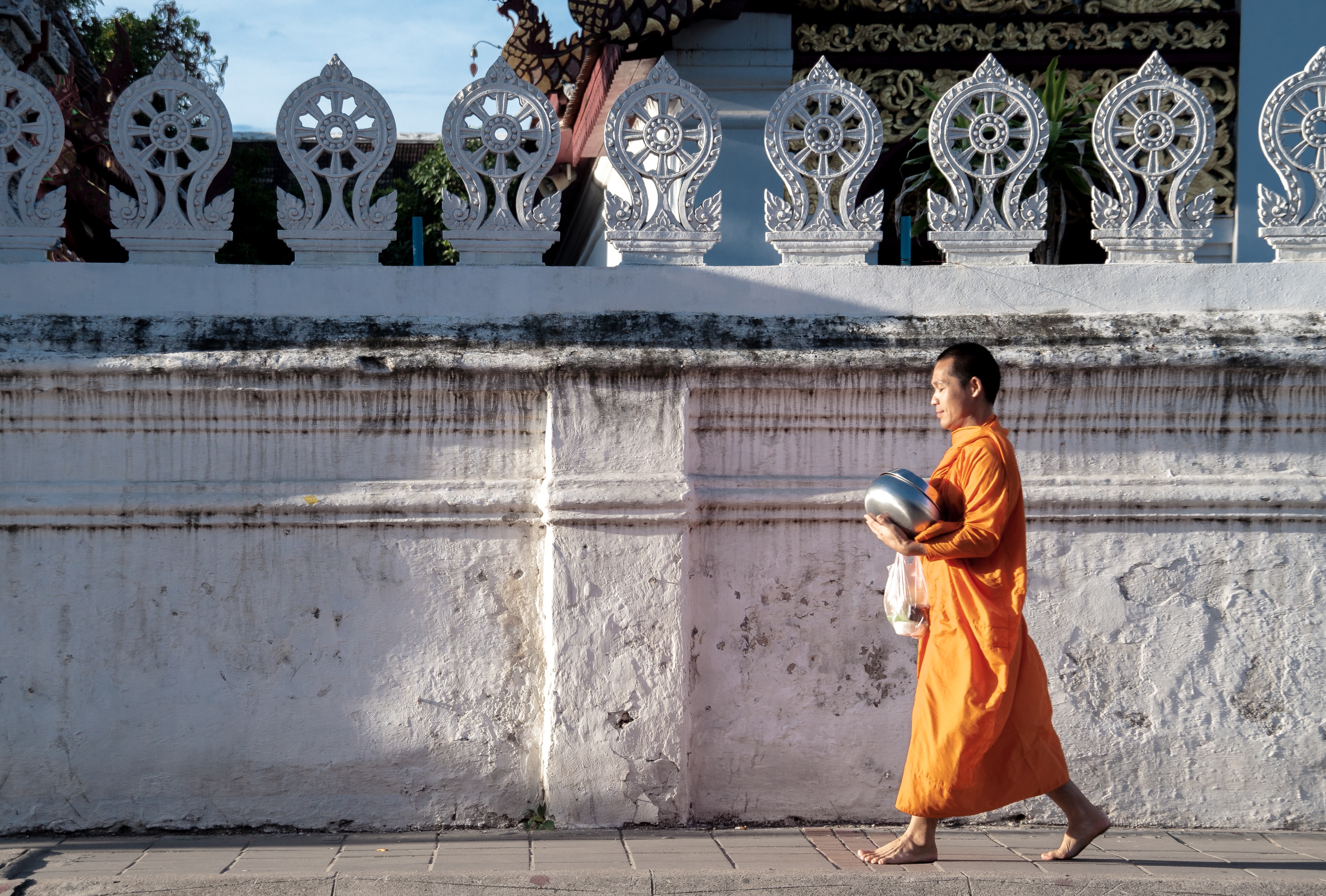 Buddhist monk walks down the street 